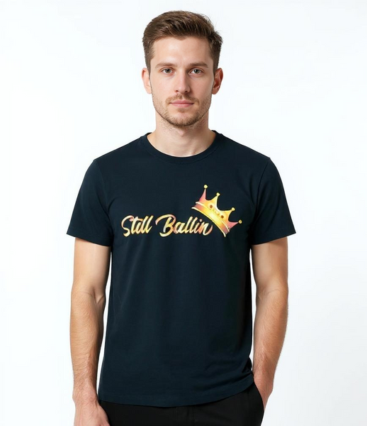 Man wearing a black t-shirt with 'Still Ballin'' text and graphic on a white background